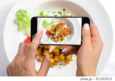 A young woman taking photo of food on smartphone, photographing meal with mobile camera 81393025