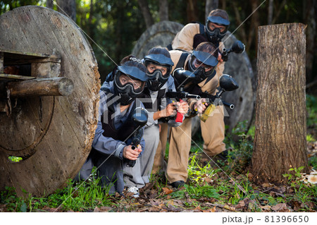 Paintball players aiming outdoors 81396650