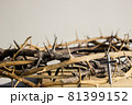 A cross with thorn crown on a wooden table.  81399152