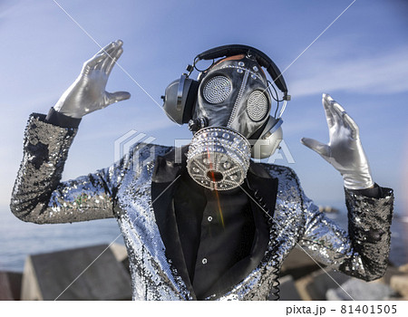 man with sparkling gas mask dancing by the sea - Stock Photo [81401505] -  PIXTA