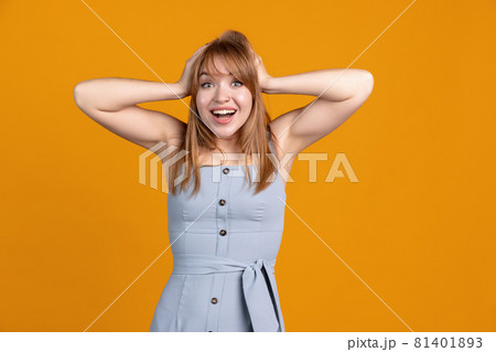 Horizontal portrait of young beautiful girl isolated on yellow studio background. Concept of human emotions, facial expression, youth, sales, ad. Horizontal portrait of young beautiful girl isolated on yellow studio background. Concept of human emotions, facial expression, youth, sales, ad. 81401893