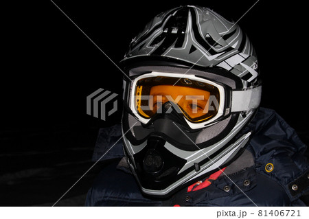 Child Wearing an ATV Helmet at Night 81406721
