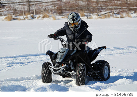 Riding a Quad in the Winter Riding a Quad in the Winter 81406739