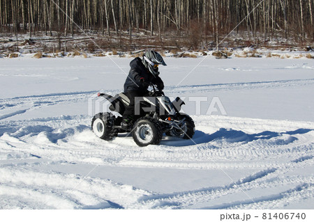 Child Driving a Quad in the Snow 81406740