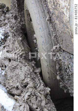 Closeup of a vehicle sinking in mud 81406752