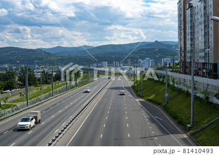 Multi-lane highway with a dividing strip. Automobile city road on a summer day. Multi-lane highway with a dividing strip. Automobile city road on a summer day. 81410493