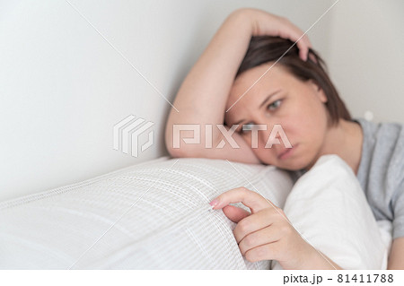 sad woman sitting on the bed holding pillow sad woman sitting on the bed holding pillow 81411788