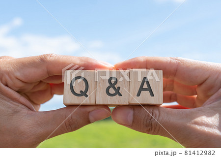 Q and A alphabet on wooden cube in hand hold with background. Question and answer meaning. 81412982