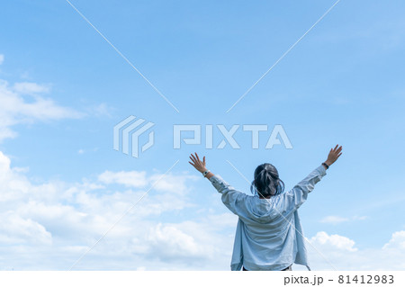 Copy space freedom lady hand rising up summer vacation and freedom concept blue sky and mountain in abstract summer background. Copy space freedom lady hand rising up summer vacation and freedom concept blue sky and mountain in abstract summer background. 81412983