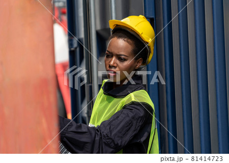 Young African American woman worker at overseas shipping container yard 81414723