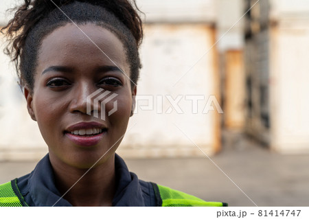 Young African American woman worker at overseas shipping container yard Young African American woman worker at overseas shipping container yard 81414747