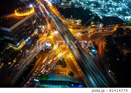 Busy highway road junction in metropolis city center at night Busy highway road junction in metropolis city center at night 81414774