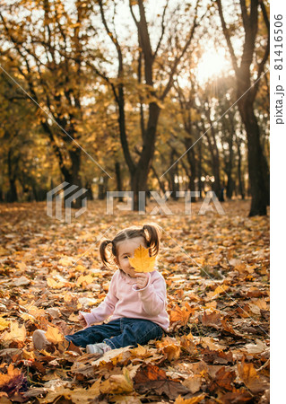 Happy family mom and toddler baby girl playing outdoors in fall park. Little girl and her mother in the autumn park. Fall activities for toddlers 81416506