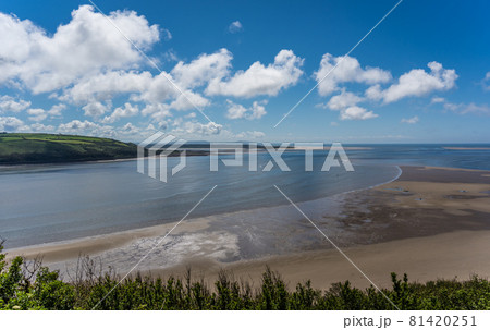 Panoramic shot of LLansteffan beach with clear blue water in southern Wales 81420251