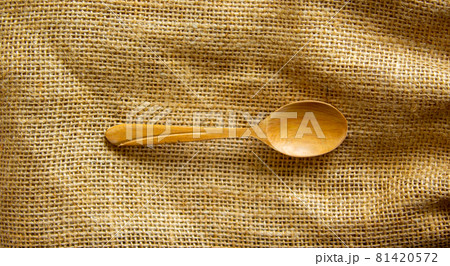 Beautiful wooden spoon isolated on canvas background. Concept. Beautiful wooden spoon isolated on canvas background. Concept. 81420572