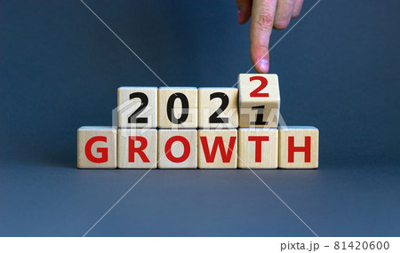 Planning 2022 growth new year symbol. Businessman turns a wooden cube and changes words 'Growth 2021' to 'Growth 2022'. Beautiful grey background, copy space. Business, 2022 growth new year concept. 81420600