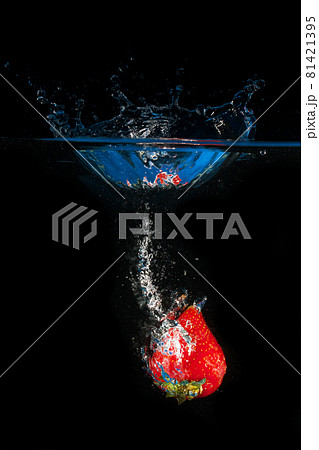 Strawberries splashing into the water 81421395