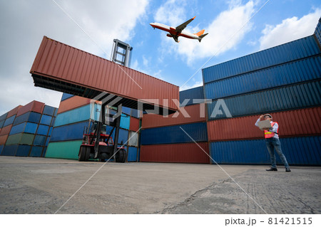 Cargo container for overseas shipping in shipyard with airplane in the sky . 81421515