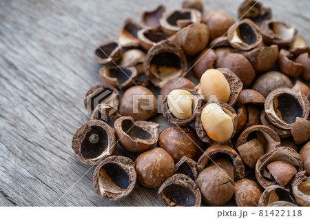 Pile of peeled Macadamia nuts on wooden table Pile of peeled Macadamia nuts on wooden table 81422118