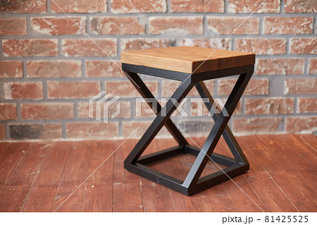 stylish stool against a red brick wall stylish stool against a red brick wall 81425525