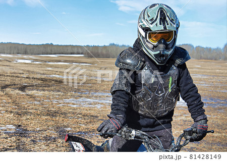 Closeup of a muddy boy in bike protection gear 81428149