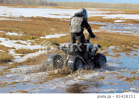 Youth quading through spring run off Youth quading through spring run off 81428151