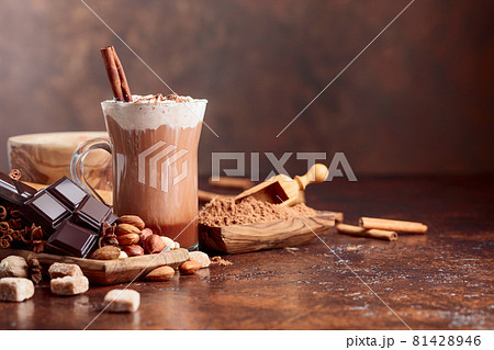 Cocoa with cream, cinnamon, chocolate pieces and various spices. Cocoa with cream, cinnamon, chocolate pieces and various spices. 81428946