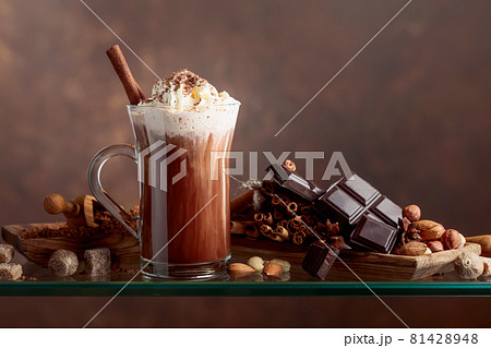 Cocoa with cream, cinnamon, chocolate pieces and various spices. Cocoa with cream, cinnamon, chocolate pieces and various spices. 81428948