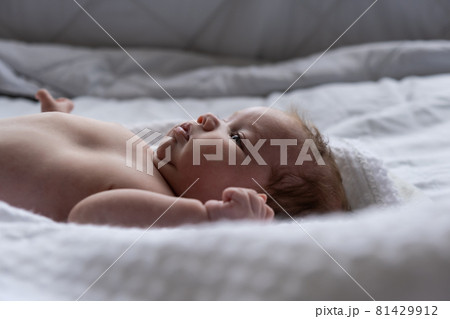 Little month old girl on a white sheet. Filmed in daylight. Little month old girl on a white sheet. Filmed in daylight. 81429912