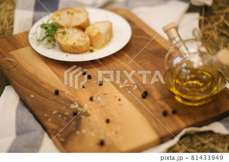 Healthy vegan breakfast concept. Whole wheat bread with olive oil. Sliced baguette on wooden table. Hay 81433949