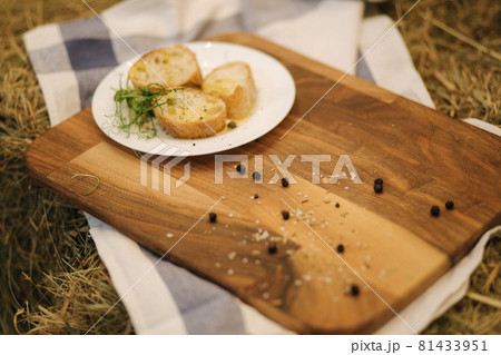 Healthy vegan breakfast concept. Whole wheat bread with olive oil. Sliced baguette on wooden table. Hay 81433951
