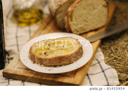 Healthy vegan breakfast concept. Whole wheat bread with olive oil. Sliced bread on wooden table. Hay 81433954