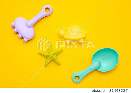 Plastic beach toy pastel color on yellow background. The development of fine motor concept. Creativity Game and summer concept. Plastic beach toy pastel color on yellow background. The development of fine motor concept. Creativity Game and summer concept. 81443227