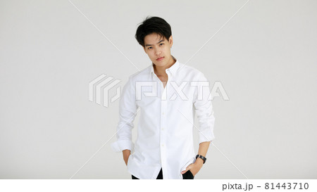 Half length shot portrait of a handsome good looking tomboy, a girl who loves to be a man, on white background Half length shot portrait of a handsome good looking tomboy, a girl who loves to be a man, on white background 81443710