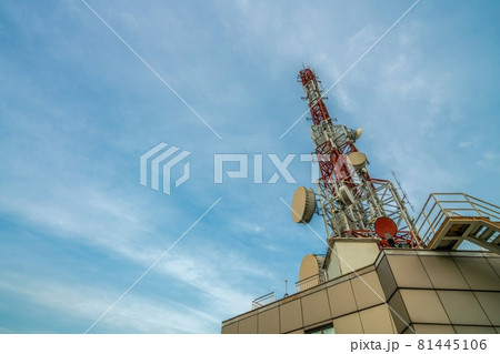 Large telecommunication tower against sky and clouds in background Large telecommunication tower against sky and clouds in background 81445106