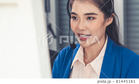 Businesswoman wearing headset working actively in office 81445161