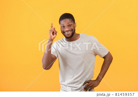 I have idea. Inspired african american man raising finger up, standing over yellow studio background I have idea. Inspired african american man raising finger up, standing over yellow studio background 81459357