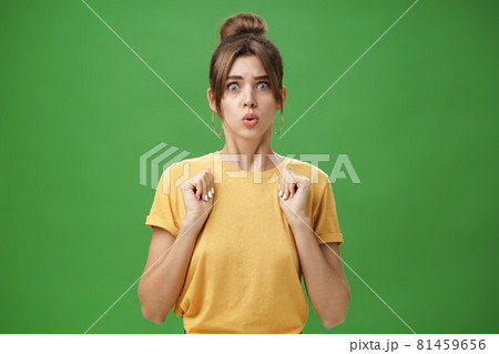Studio shot of silly insecure and timid young wife feeling troubled and concerned, pressing hands to body folding lips and frowning looking scared and nervous facing troublesome situation, worry Studio shot of silly insecure and timid young wife feeling troubled and concerned, pressing hands to body folding lips and frowning looking scared and nervous facing troublesome situation, worry 81459656
