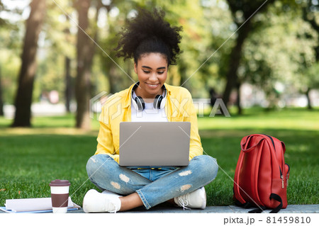 African American College Girl Using Laptop Sitting Learning In Park African American College Girl Using Laptop Sitting Learning In Park 81459810