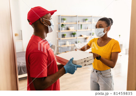 African American Woman In Mask Receiving Pizza From Deliveryman Indoor 81459835