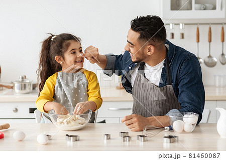 Arab Family Dad And Little Daughter Baking In Kitchen And Having Fun Arab Family Dad And Little Daughter Baking In Kitchen And Having Fun 81460087