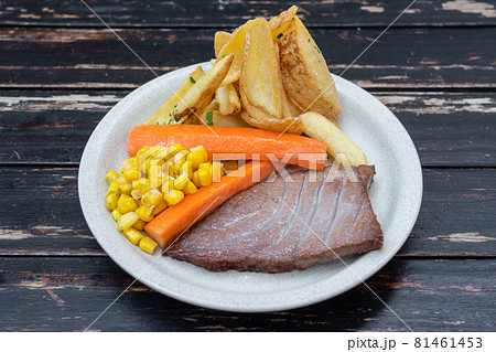 Conceptual dish of pork, beef, chicken. Garnish with carrots, corn. Close-up. 81461453