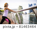 Close-up of attractive happy female athlete stretching 81463464