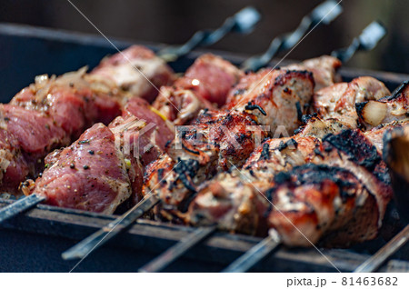 Fresh shish kebab on skewers is fried on the grill. 81463682