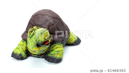 Concrete tortoise garden figure painted with colored paints, landscape object in the form of a cheerful turtle with a brown shell and a green head isolated on a white background. 81466383