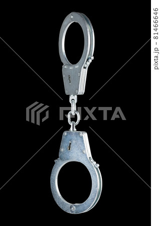 real zinc plated steel police handcuffs closed hanging vertically, isolated on black background real zinc plated steel police handcuffs closed hanging vertically, isolated on black background 81466646