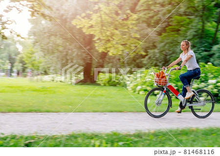 Beautiful and cheerful adult woman enjoy bike ride in sunny urban outdoor leisure activity in the city. Beautiful and cheerful adult woman enjoy bike ride in sunny urban outdoor leisure activity in the city. 81468116