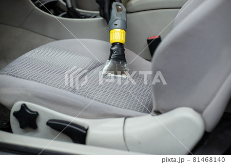 Man car detailing studio worker cleaning car textile upholstery Man car detailing studio worker cleaning car textile upholstery 81468140