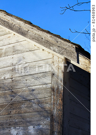 Edge of an Abandoned Farm Shed Against a Blue Sky 81468963