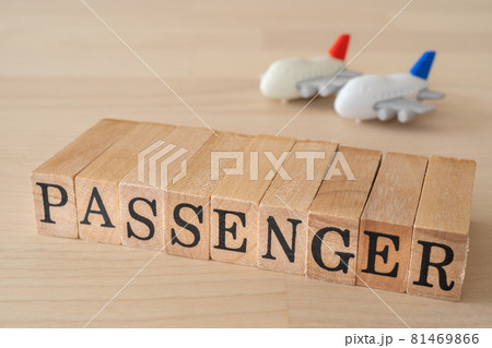 飛行機の乗客 Passenger と書かれたスタンプと飛行機のおもちゃの写真素材